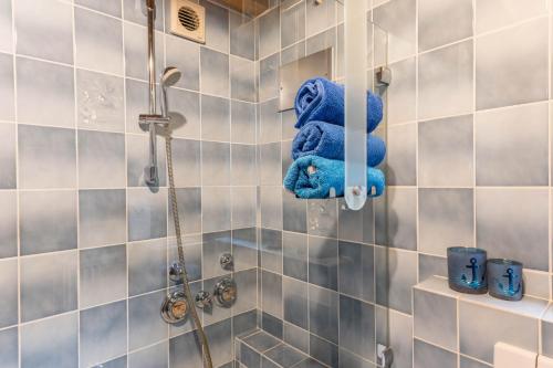 a bathroom with a shower with blue towels at Appartement Böhler 2 in Reichenau