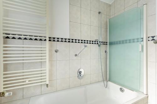 a bathroom with a shower and a bath tub at Ferienwohnung am Kurpark Brilon in Brilon