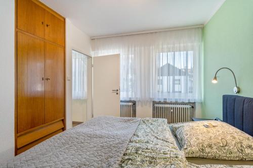 a bedroom with a bed and a large window at Ferienwohnung am Kurpark Brilon in Brilon