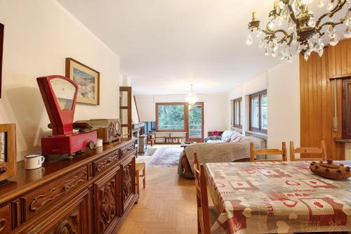 a living room with a table and a dining room at Maison La Truite in Morgex