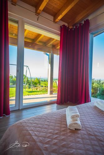 a bedroom with a bed with a red curtain at Casa Vacanze Elios in Valdamonte
