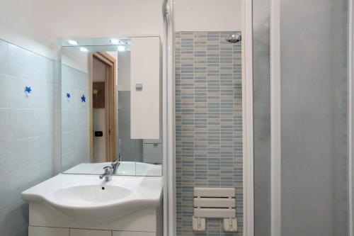 a white bathroom with a sink and a shower at Santa Lucia in Imperia
