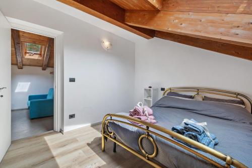 a bedroom with a bed and a blue couch at Maison Nature e Relax Zaffiro in Osiglia