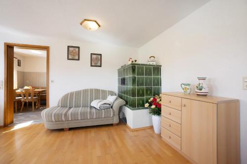 a living room with a couch and a dresser at Landhaus Moos in Argenbühl