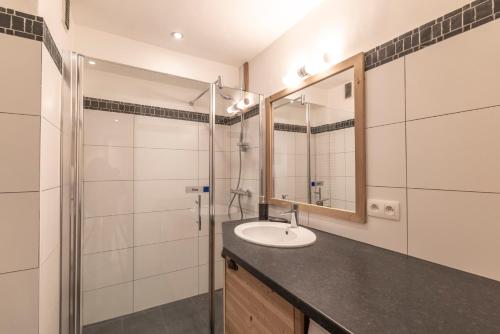 a bathroom with a sink and a shower at Appartement au centre de megève in Megève