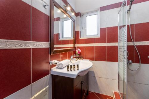 a bathroom with a sink and a shower at Apartment with Sea view B in Tsoukalades
