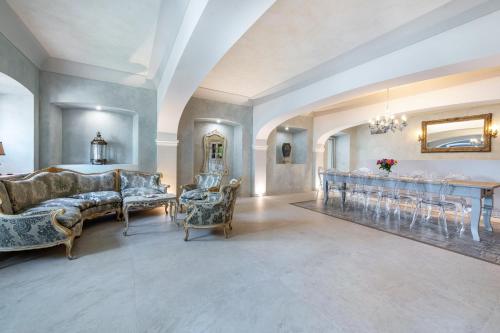 a large living room with a table and chairs at Abaye I Champagne Charm Adults Only in Soiano del Lago