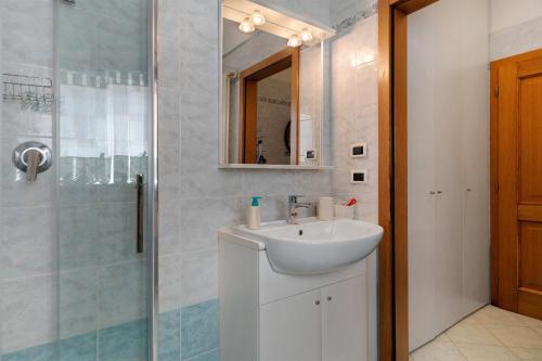 a bathroom with a sink and a shower at Ciclamino Superior Otto in San Lorenzo in Banale