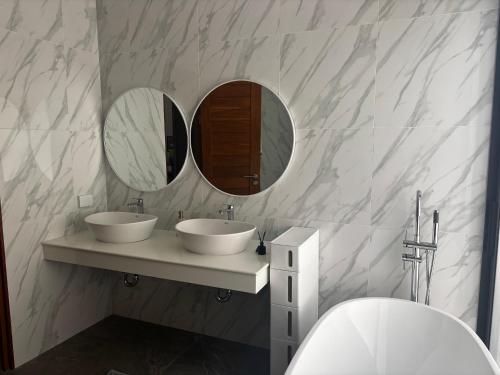 a bathroom with two sinks and two mirrors at villa du bonheur in Koh Samui
