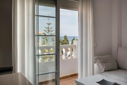 a living room with a window and a couch at Ático el morche in El Morche
