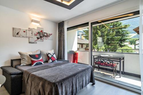 a bedroom with a bed and a balcony with a fireplace at Apartment il cuore rosso in Naturno