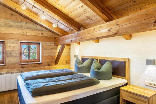a bedroom with a bed in a wooden house at Apartment Kracherlemoos in Seefeld in Tirol