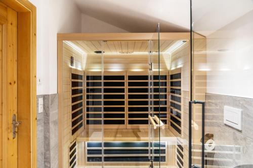 a walk in wine cellar with a glass door at Apartment Kracherlemoos in Seefeld in Tirol
