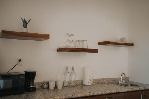 a kitchen with a counter with bottles on the wall at 7 Valles in Valle de Guadalupe
