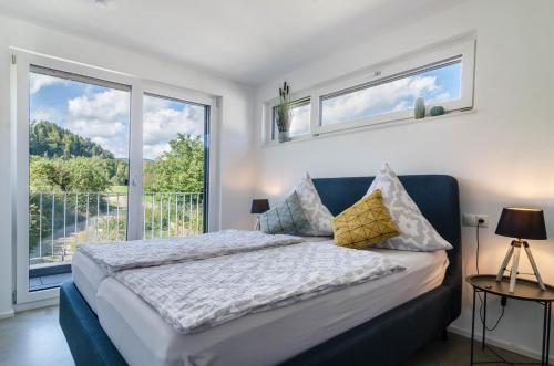 a bedroom with a bed and a large window at Landtraum 17 in Wittenhofen