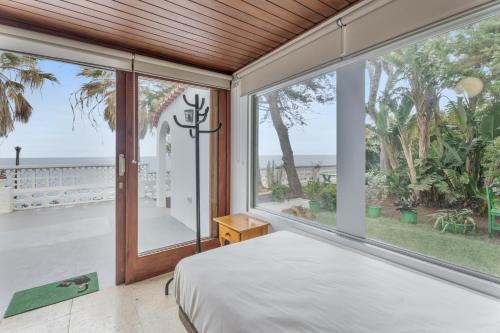 a bedroom with a view of the ocean at Casa Mara in Sauzal