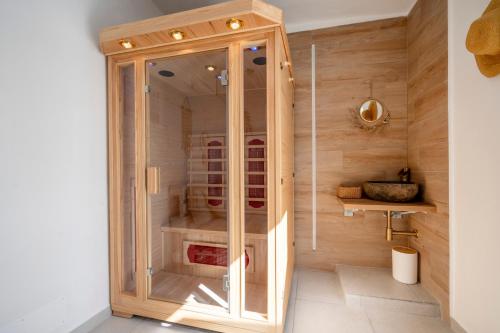 a large wooden cabinet in a bathroom with wooden walls at Dimora Giulia Luxury Suite and Room in Castellana Grotte