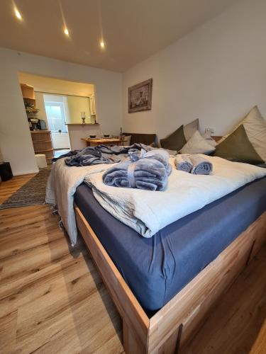 a large bed with blue blankets on it in a room at Rosenzauber Kraxler Pärchen in Weißenstadt