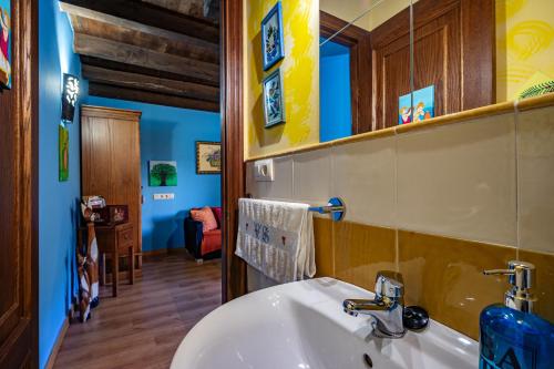 a bathroom with a sink and a mirror at Teixo in Vega de Logares
