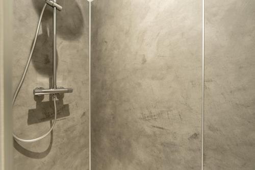 a shower in a bathroom with a glass door at L'écrin De La Sèvre in Cugand
