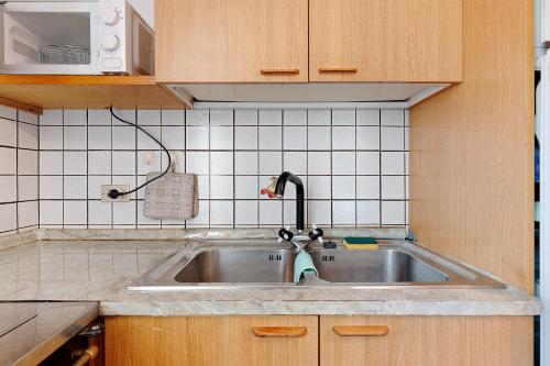 a kitchen sink with a faucet on top of it at Casa Mariotta in Castello di Fiemme