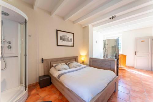 a bedroom with a bed and a bath tub at Mas De Charme Caumont Sur Durance in Caumont-sur-Durance