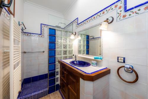 a blue and white bathroom with a sink and a shower at Casa Toni in Portocolom