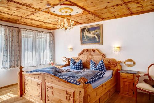 a bedroom with a wooden bed with blue pillows at Ferienwohnung Lapislazuli in Mittenwald