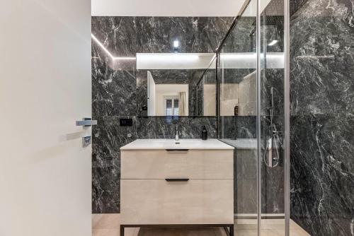 a bathroom with a sink and a shower at App 206 Palazzo Cavour in Bolzano