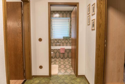 a bathroom with a walk in shower next to a door at Ferienwohnung Lilly in Garmisch