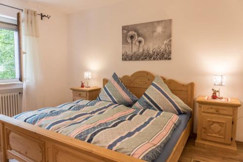 a bedroom with a wooden bed with two night stands at Ferienwohnung Lilly in Garmisch