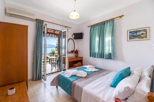 a bedroom with a bed and a balcony at Nikoleta Apartment 2 in Nikiana