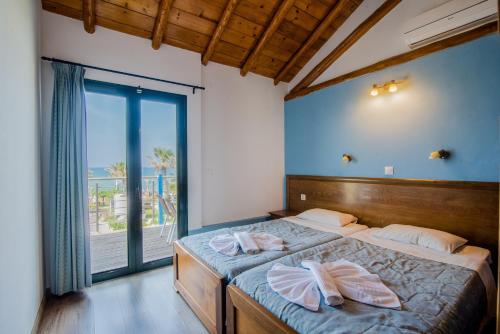 a bedroom with a bed with two towels on it at Mirage Arillas Maisonette A in Arillas