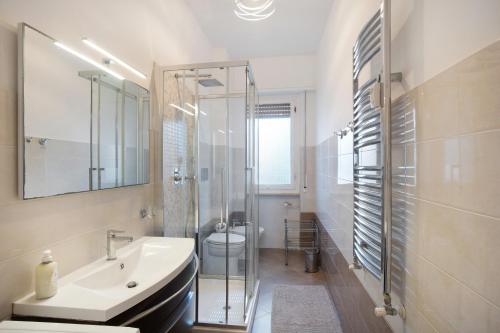 a bathroom with a sink and a toilet and a shower at Albenga Mary 43 6 in Albenga