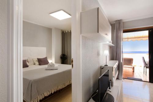 a bedroom with a bed and a view of the ocean at Las Fuentes in Arona