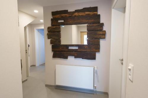 a hallway with a mirror on the wall at Ferienwohnung Hummel in Gammertingen