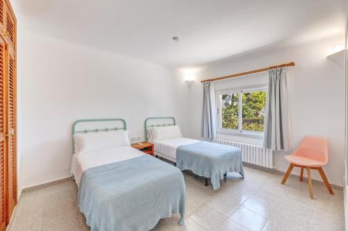 a bedroom with two beds and a window at Sant Antoni in Santanyi