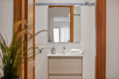 a bathroom with a sink and a mirror at Suite Cava in Arrecife