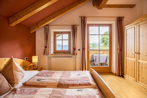a bedroom with a bed and a window at Oberplunerhof - Fewo Bruneck in Colli in Pusteria