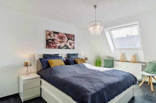 a bedroom with a bed with a blue comforter at Fewo-Keinath in Winterlingen