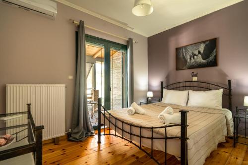 a bedroom with a large bed with towels on it at Villa Koutoupakia in Kefallonia
