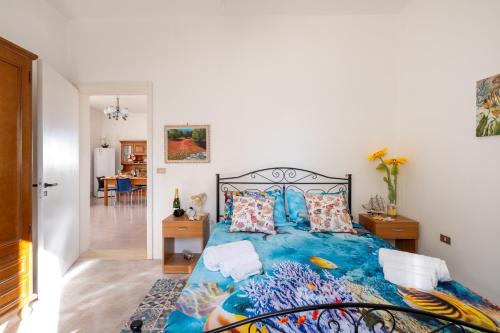 a bedroom with a large blue bed with pillows at Villa Privata Spiaggia Del Sole in Porto Cesareo