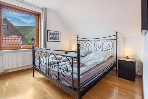 a bedroom with a bed and a large window at Storchenblick in Wunstorf