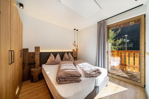 a bedroom with a bed and a large window at Grogg 608 Apt I in Martello