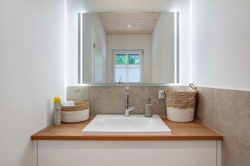 a bathroom with a sink and a mirror at Chalet Foret - Ferienhaus in Todtnauberg