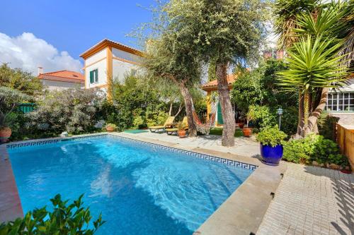 a swimming pool in the backyard of a house at Little Paradise 25 min from Lisbon in Azeitao