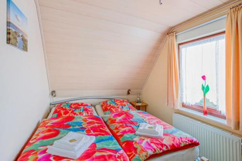 a bed in a small room with a window at Ferienwohnung Itzehoe in Itzehoe