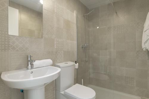 a bathroom with a toilet and a sink and a shower at Palacio de pilas 22 in Zahara de los Atunes