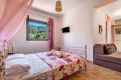 a bedroom with a bed and a window and a chair at Alkionides Apartment 1 in Agios Nikitas