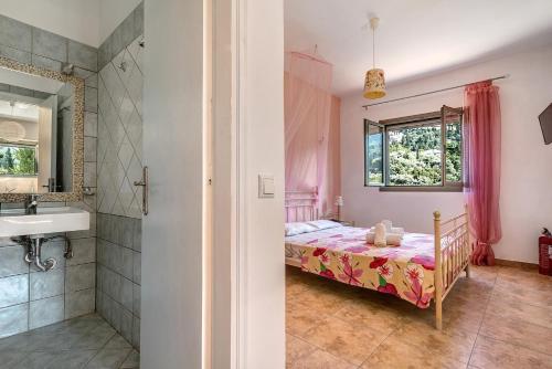 a bedroom with a bed and a sink and a shower at Alkionides Apartment 1 in Agios Nikitas